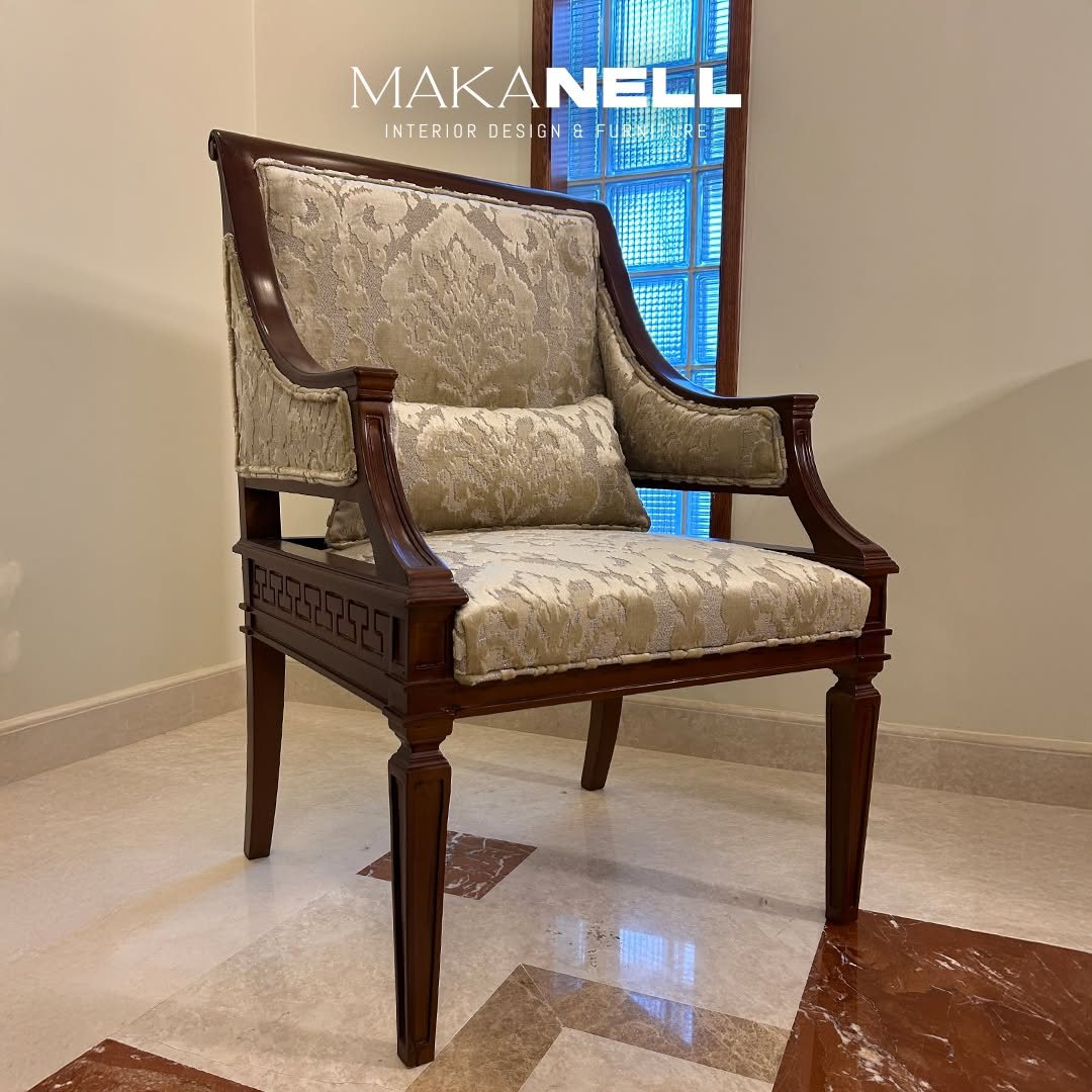Carved timber armchair with patterned upholstery